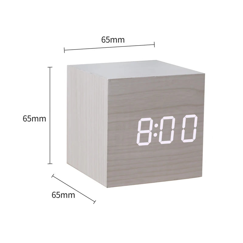 Cube-shaped digital clock with dimensions labeled on a white background