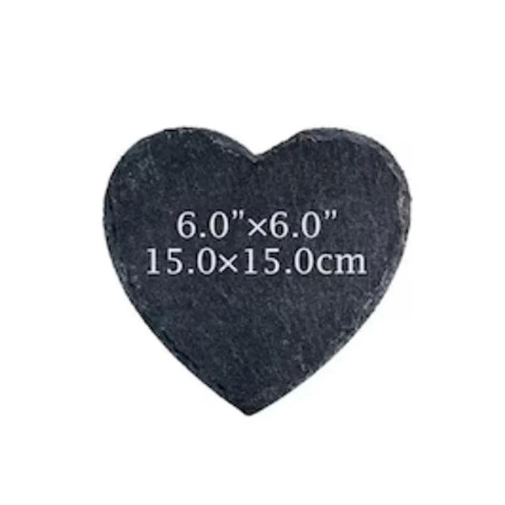 Heart-shaped black stone with measurements on a white background