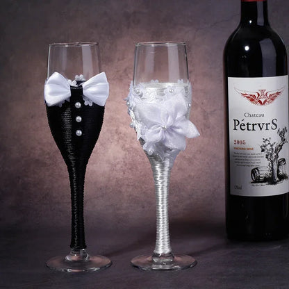 Two decorative wine glasses with a bottle of Chateau Petrus wine on a dark background