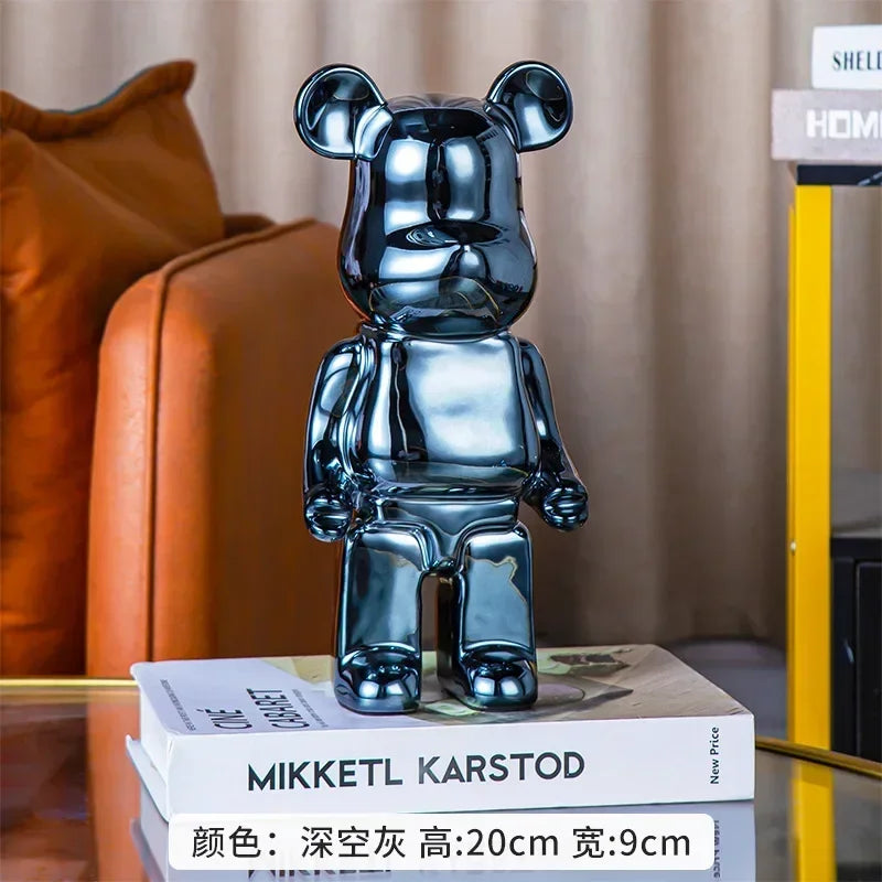 Metallic bear-shaped object on a stack of books with a blurred background