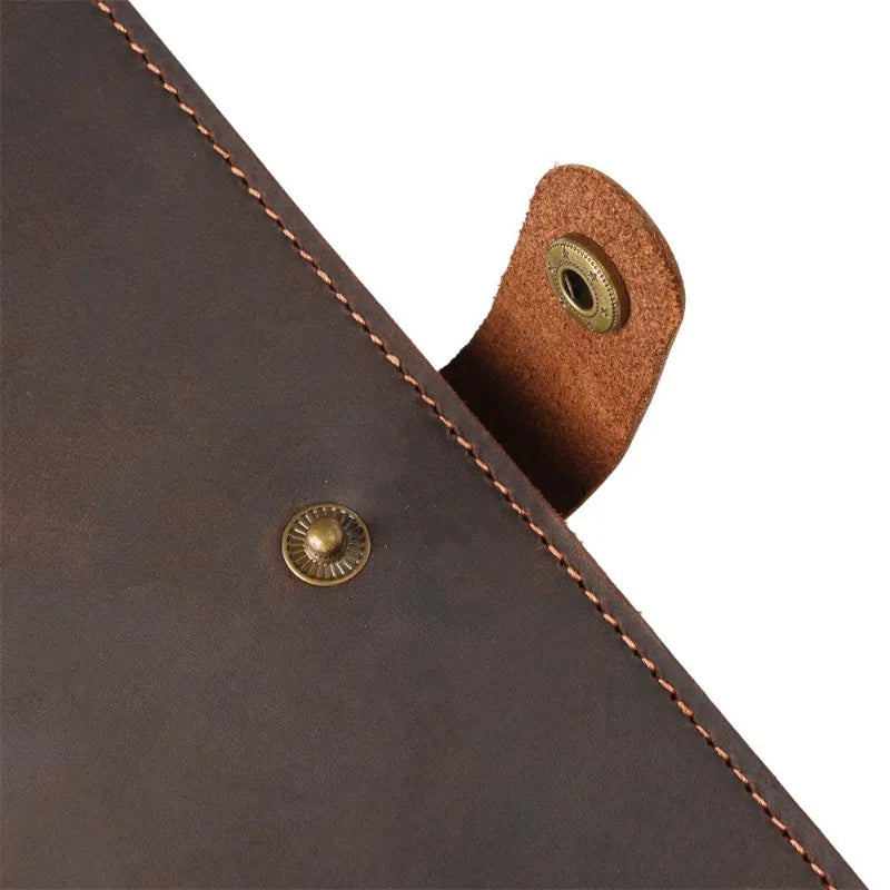 Close-up of a brown leather product with stitching details on a white background