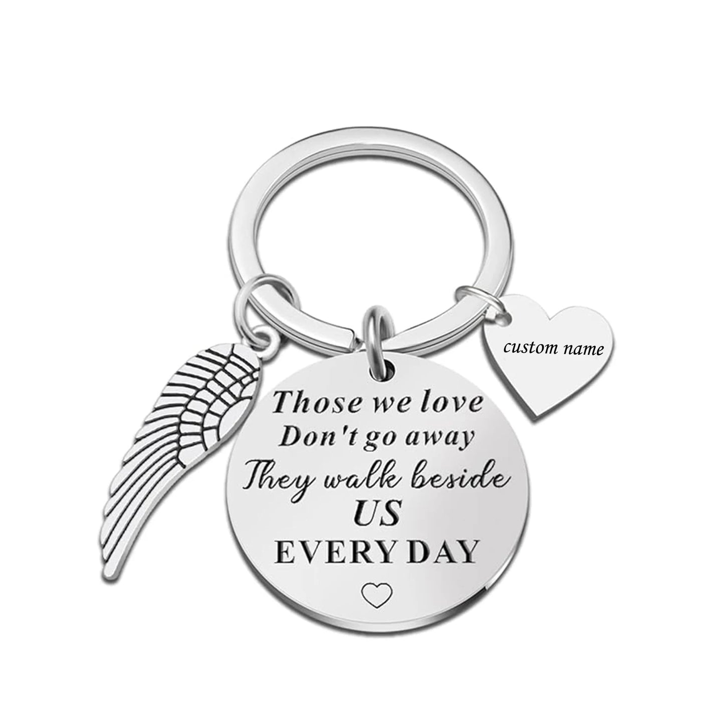 Keychain with angel wing, heart, and engraved message on a white background