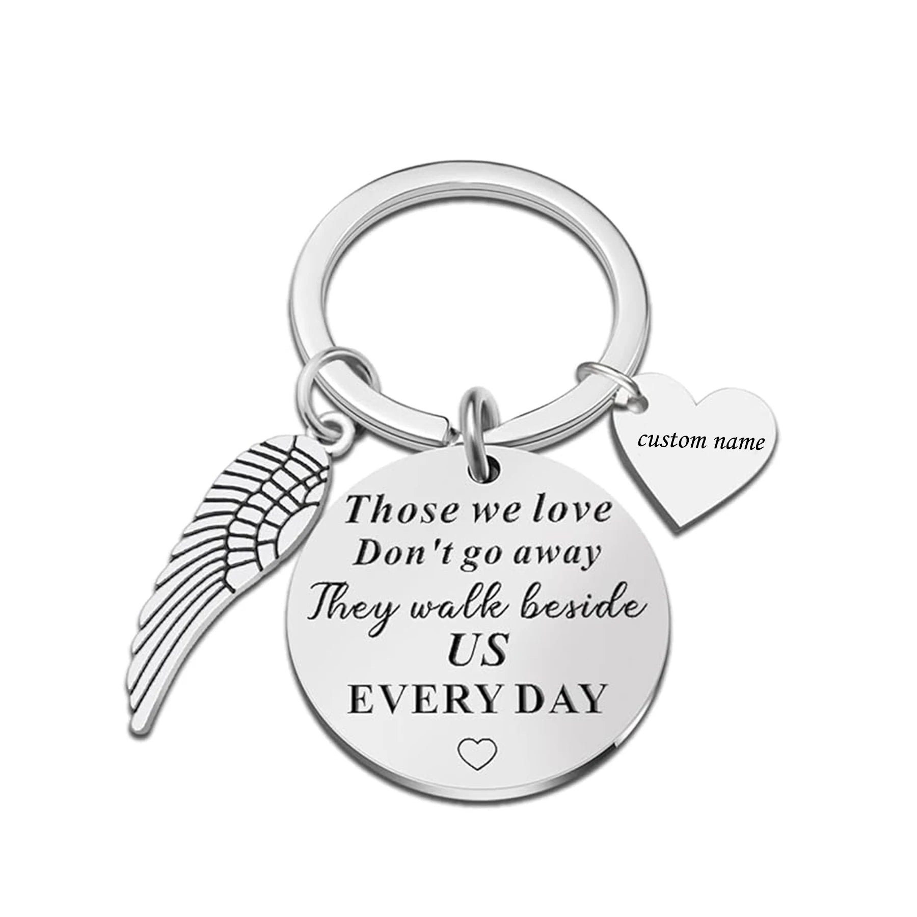 Keychain with angel wing, heart, and engraved message on a white background