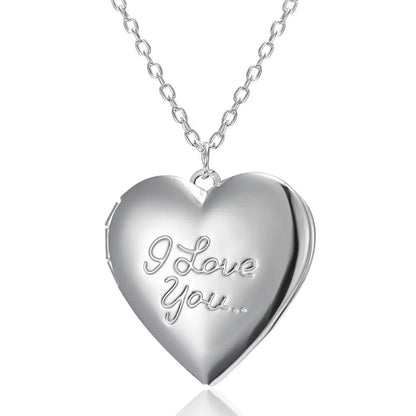 Silver heart-shaped locket with 'I Love You' engraving on a white background