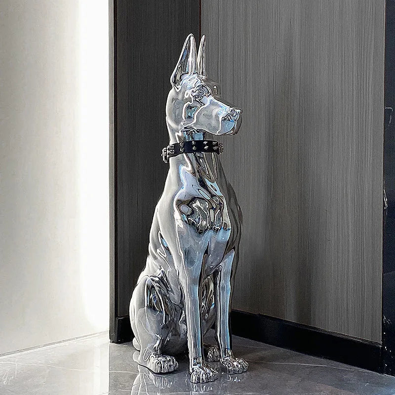 Silver dog statue on a reflective surface with a neutral background