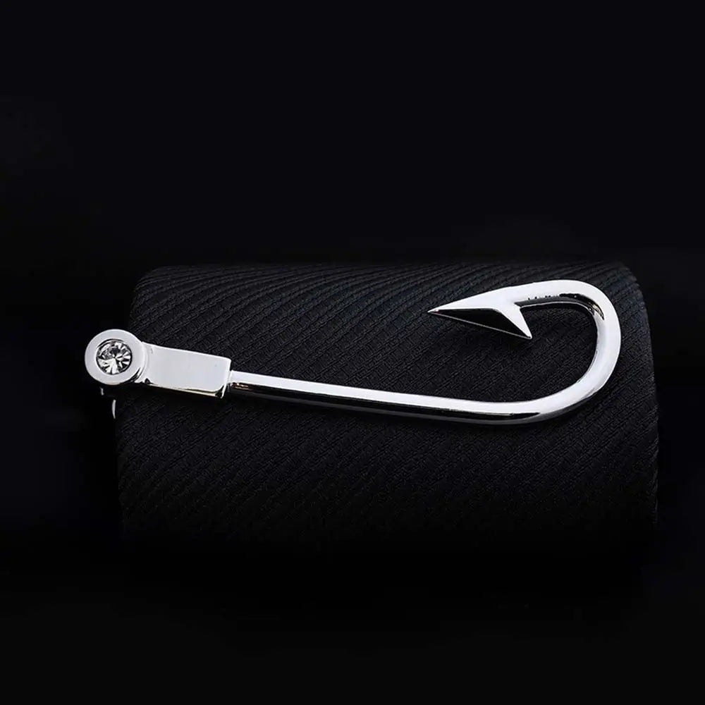 Metal fishing hook on a black textured background
