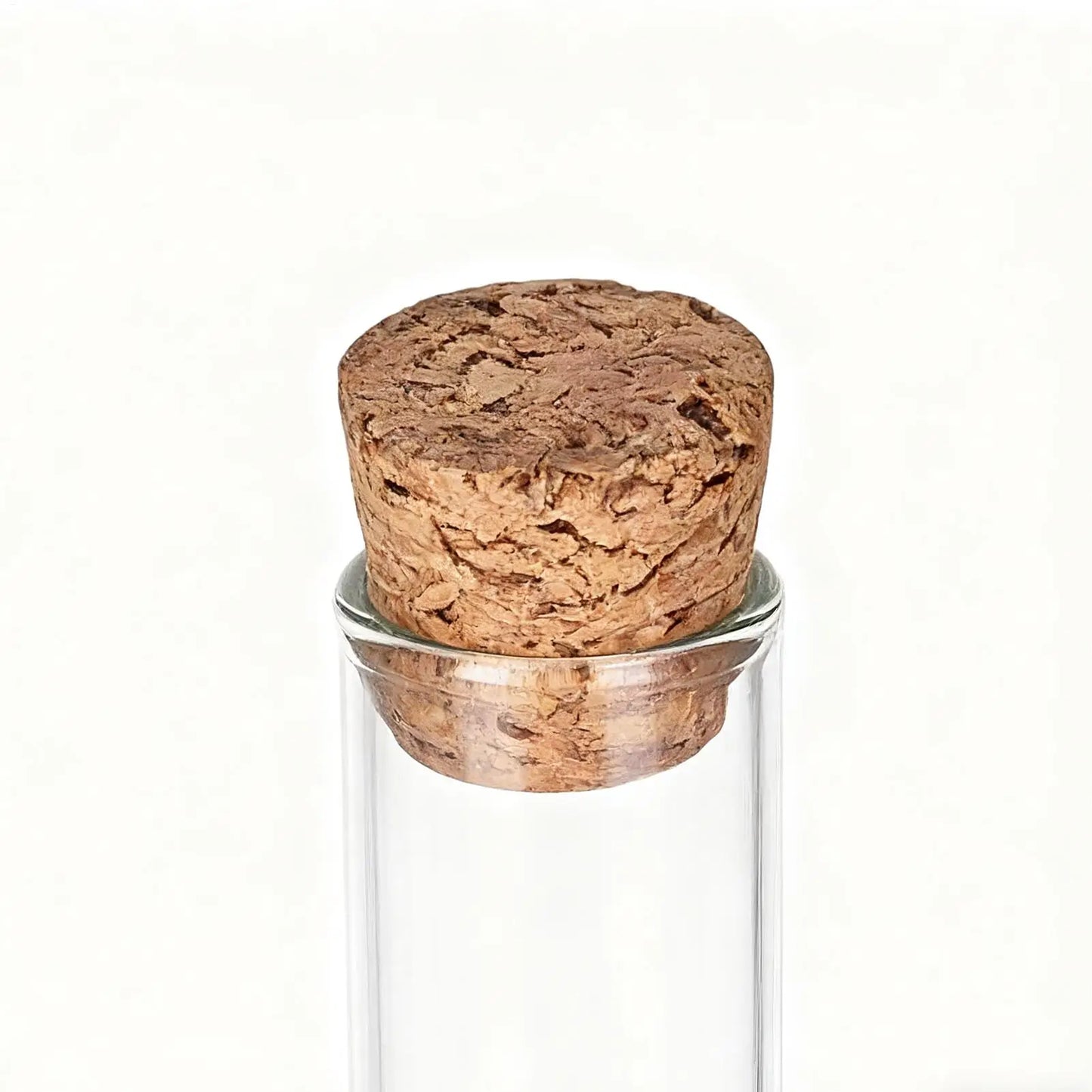 Glass container with a cork stopper on a white background