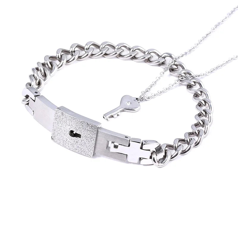 Silver chain bracelet with key and lock charm on a white background