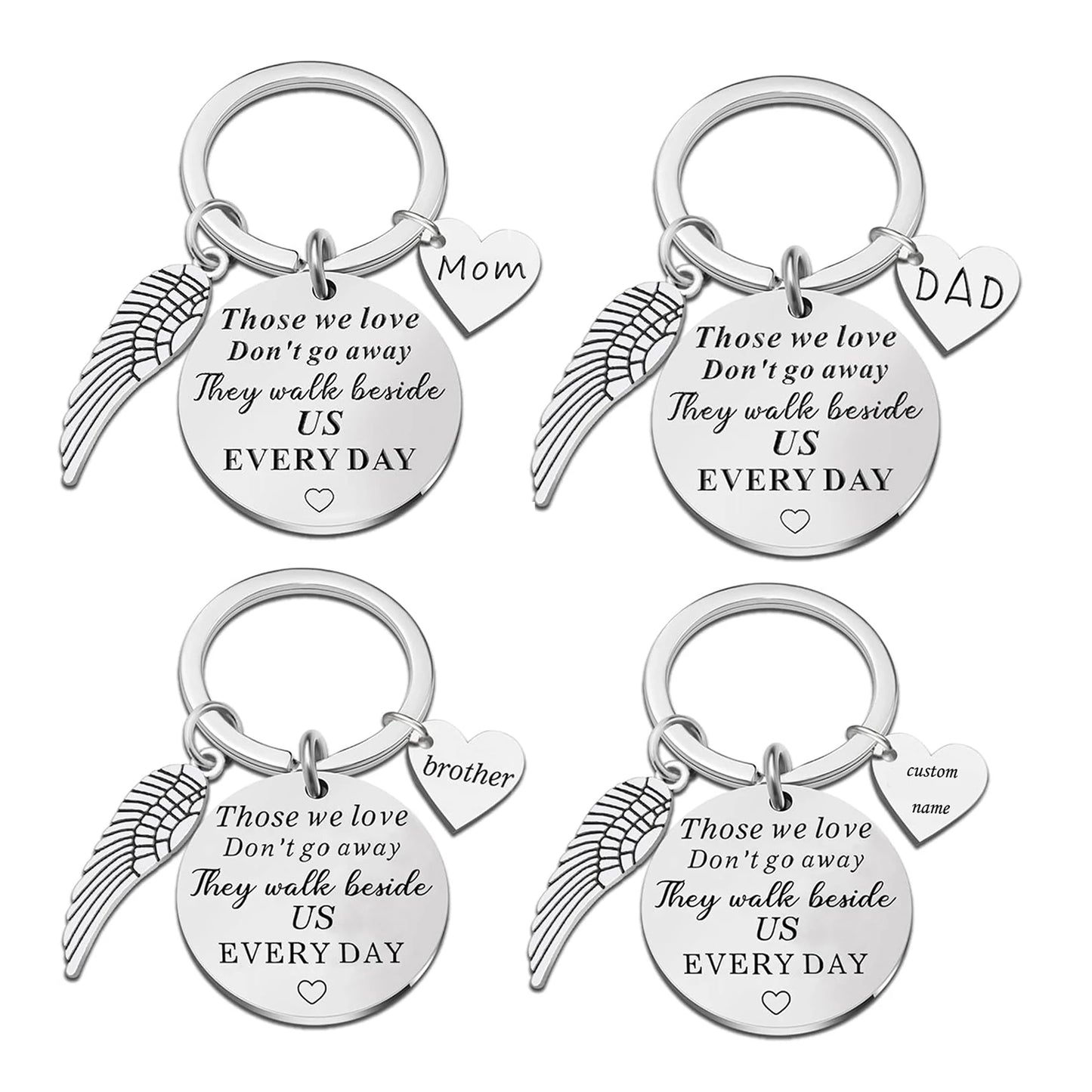 Set of four silver keychains with angel wing designs and engraved text on a white background.