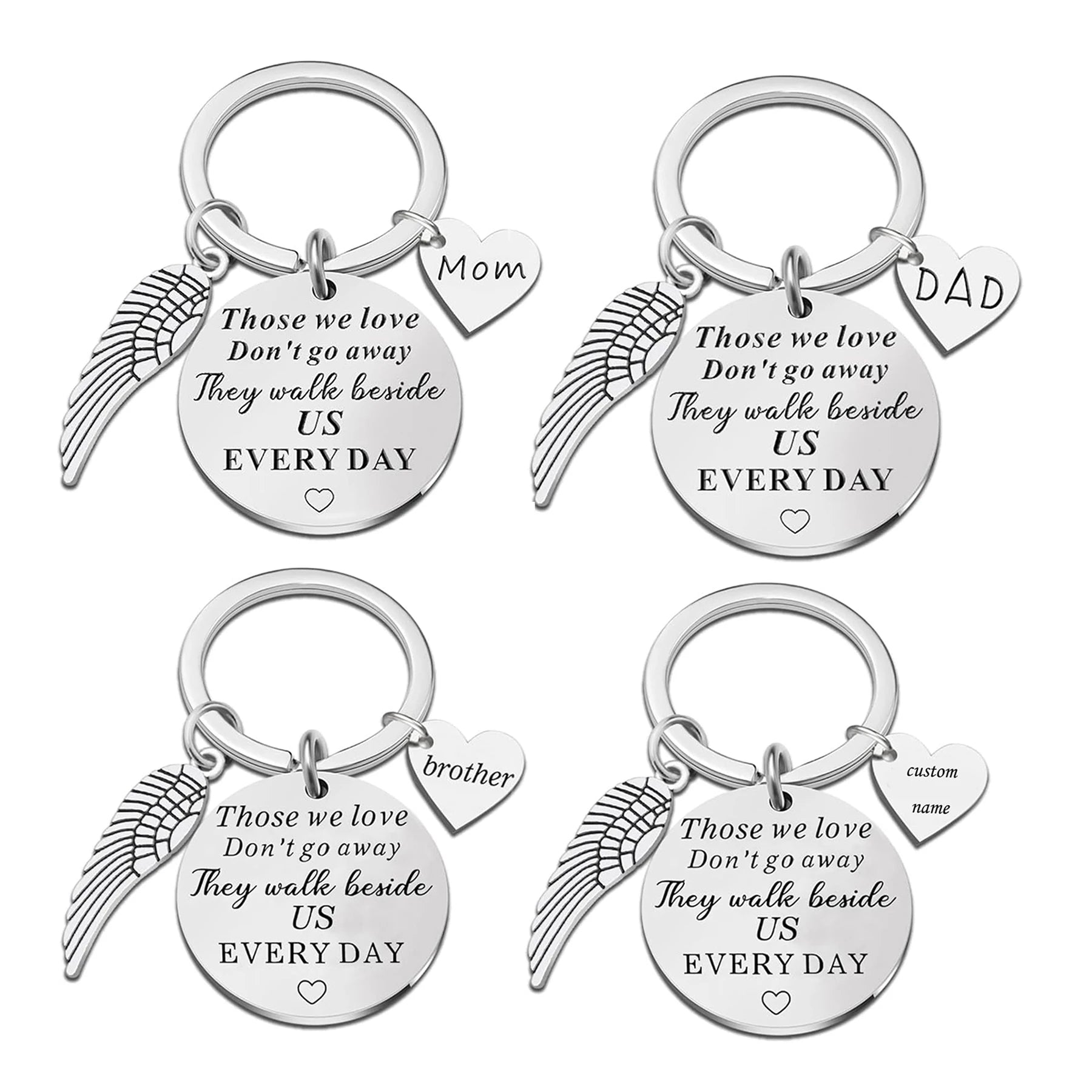 Set of four silver keychains with angel wing designs and engraved text on a white background.