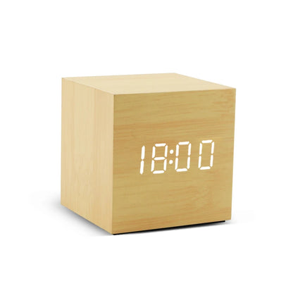 Wooden cube clock with digital time display on a white background