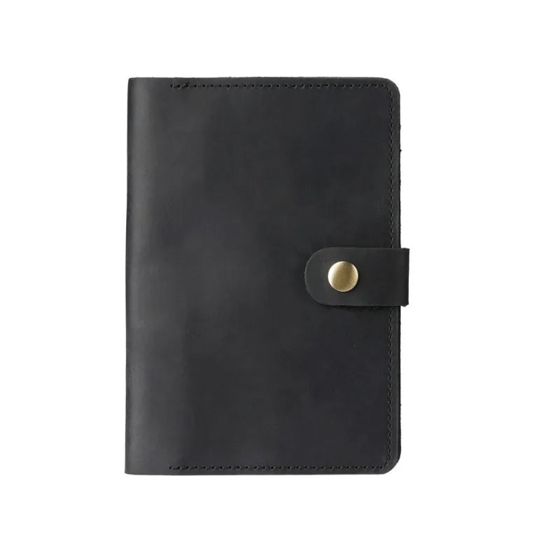 Black leather notebook with a gold buckle on a white background