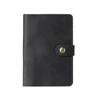 Black leather notebook with a gold buckle on a white background