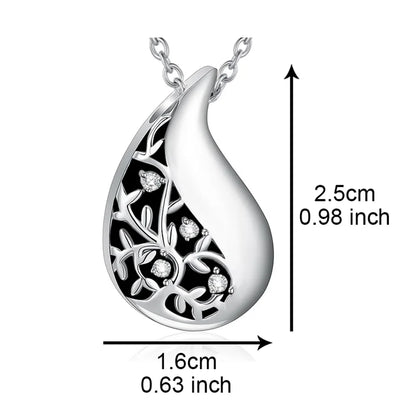 Silver teardrop-shaped pendant with floral design and measurements on a white background