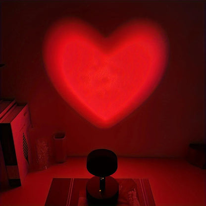 Heart-shaped light projection on a dark wall with a red hue.
