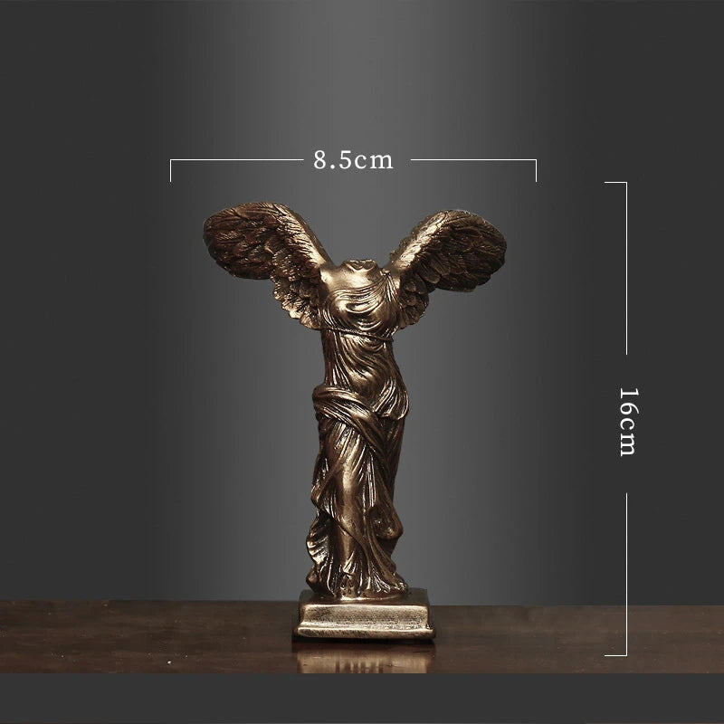Bronze statue of a winged figure with dimensions on a dark background
