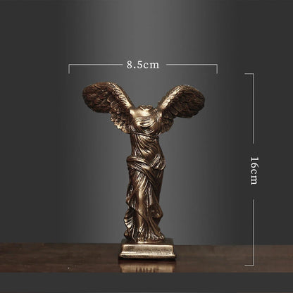 Bronze statue of a winged figure with dimensions on a dark background