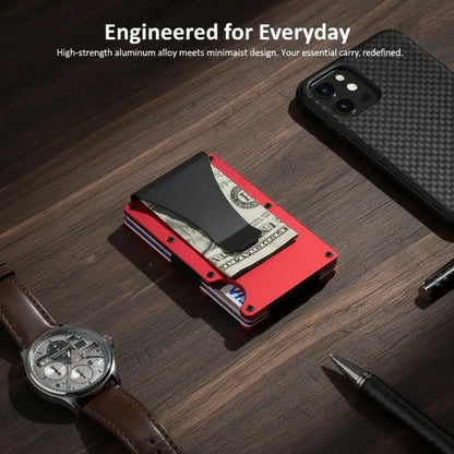 Red wallet with money clip on a wooden surface with phone, watch, and pen.