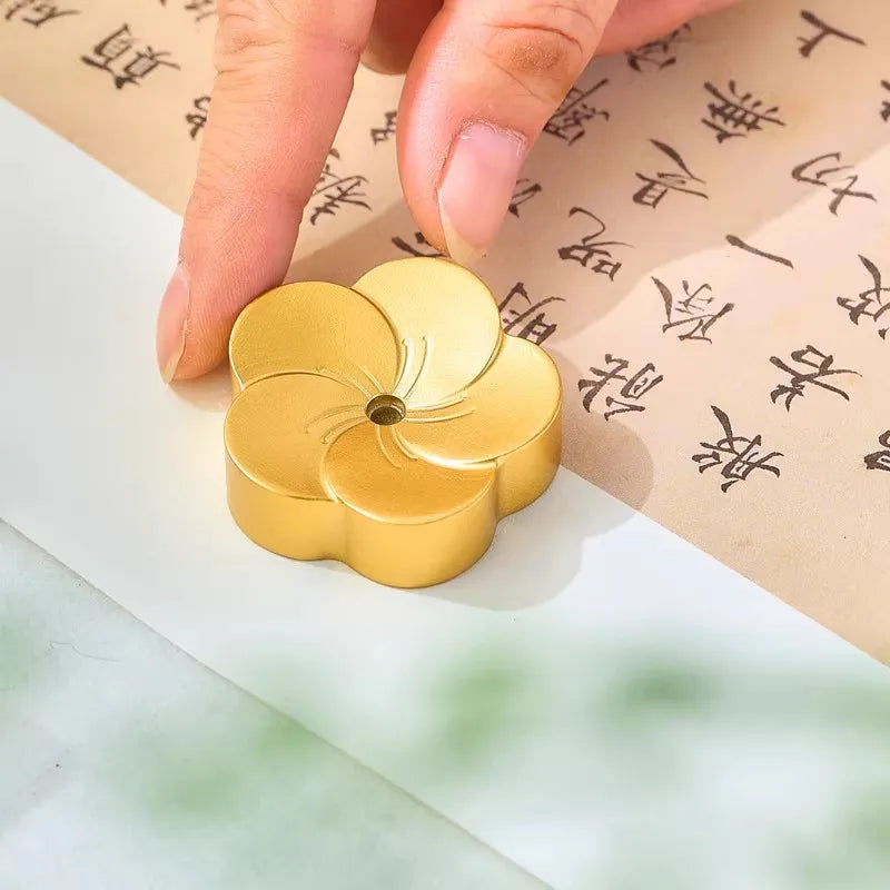 Gold flower-shaped stamp on a piece of paper with Chinese text