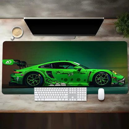 Green sports car on a desk mat with a keyboard and mouse.