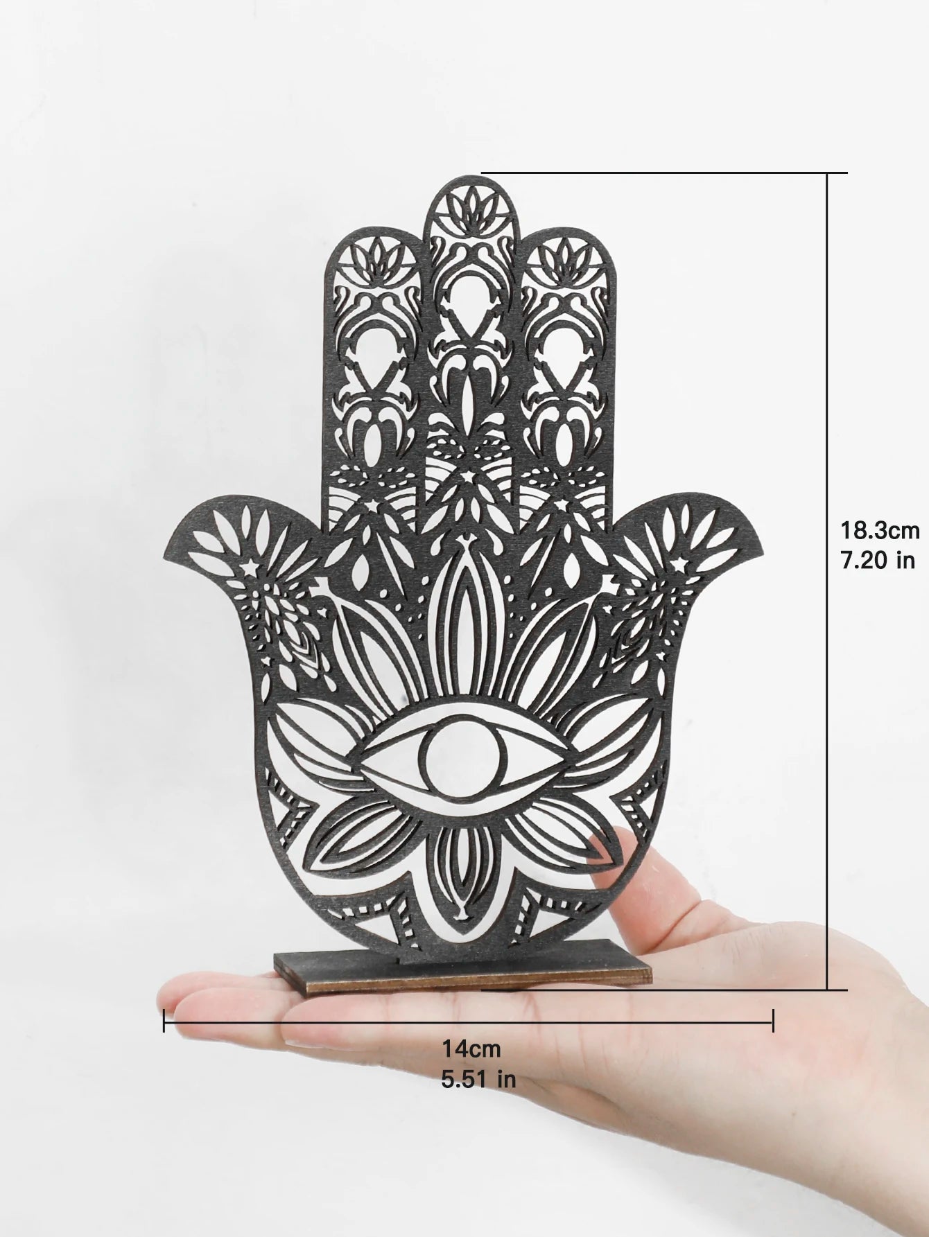 Decorative Hamsa hand with intricate patterns held in a hand, showing dimensions on a white background.