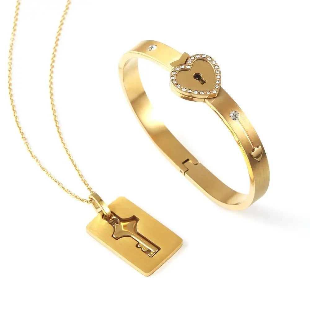 Gold bracelet and necklace set on a white background