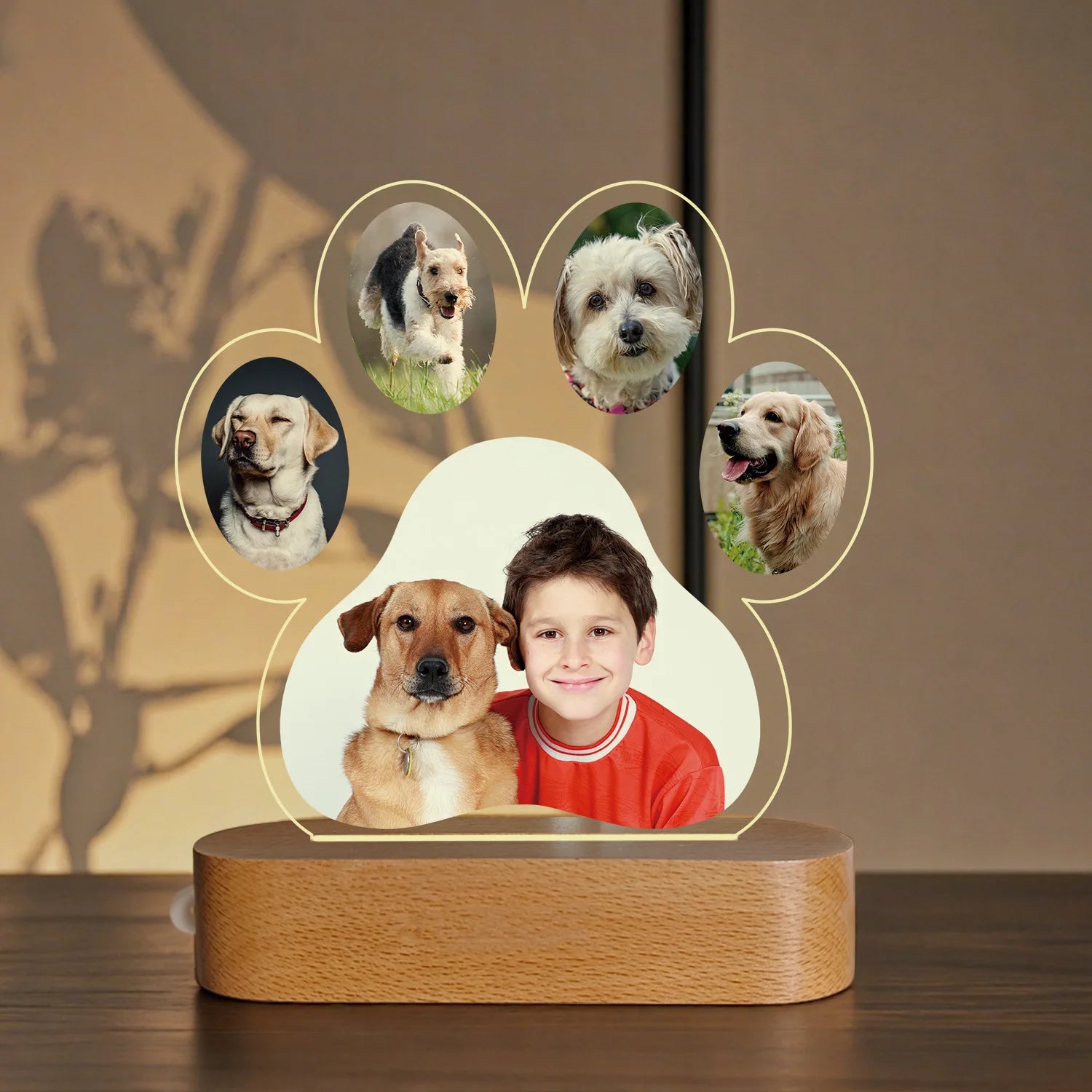 Decorative lamp with a wooden base featuring circular cutouts of dogs and a central photo of a boy.