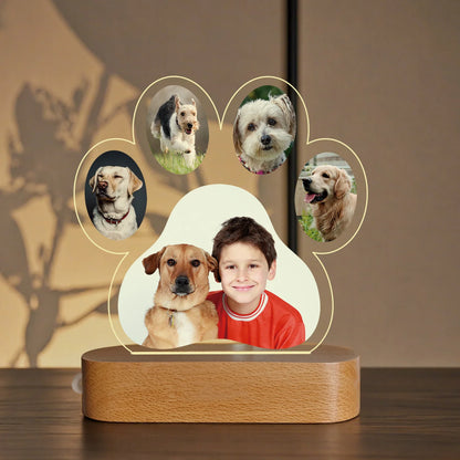 Decorative lamp with a wooden base featuring circular cutouts of dogs and a central photo of a boy.