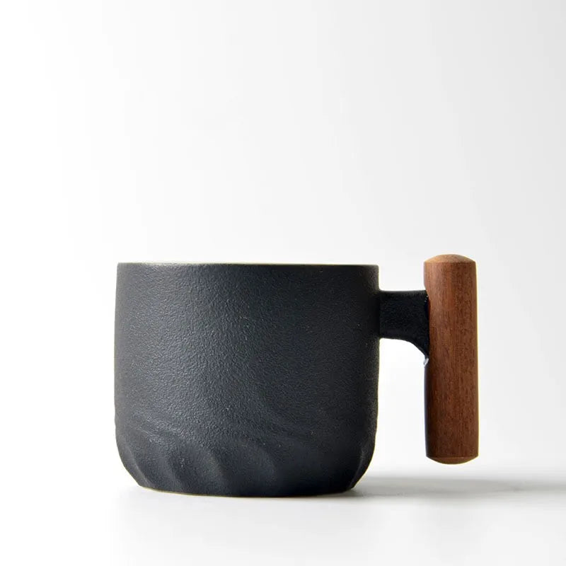Black mug with a wooden handle on a white background
