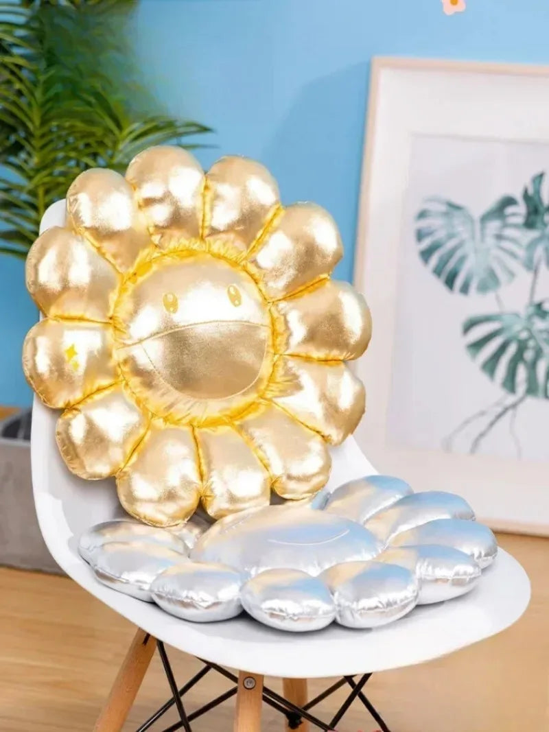 Decorative pillow shaped like a sun with metallic gold and silver design on a chair.