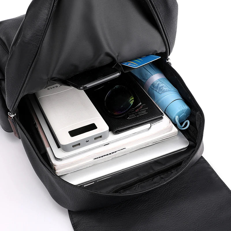 Black backpack with electronic devices and a water bottle inside