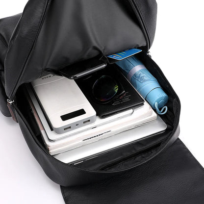 Black backpack with electronic devices and a water bottle inside