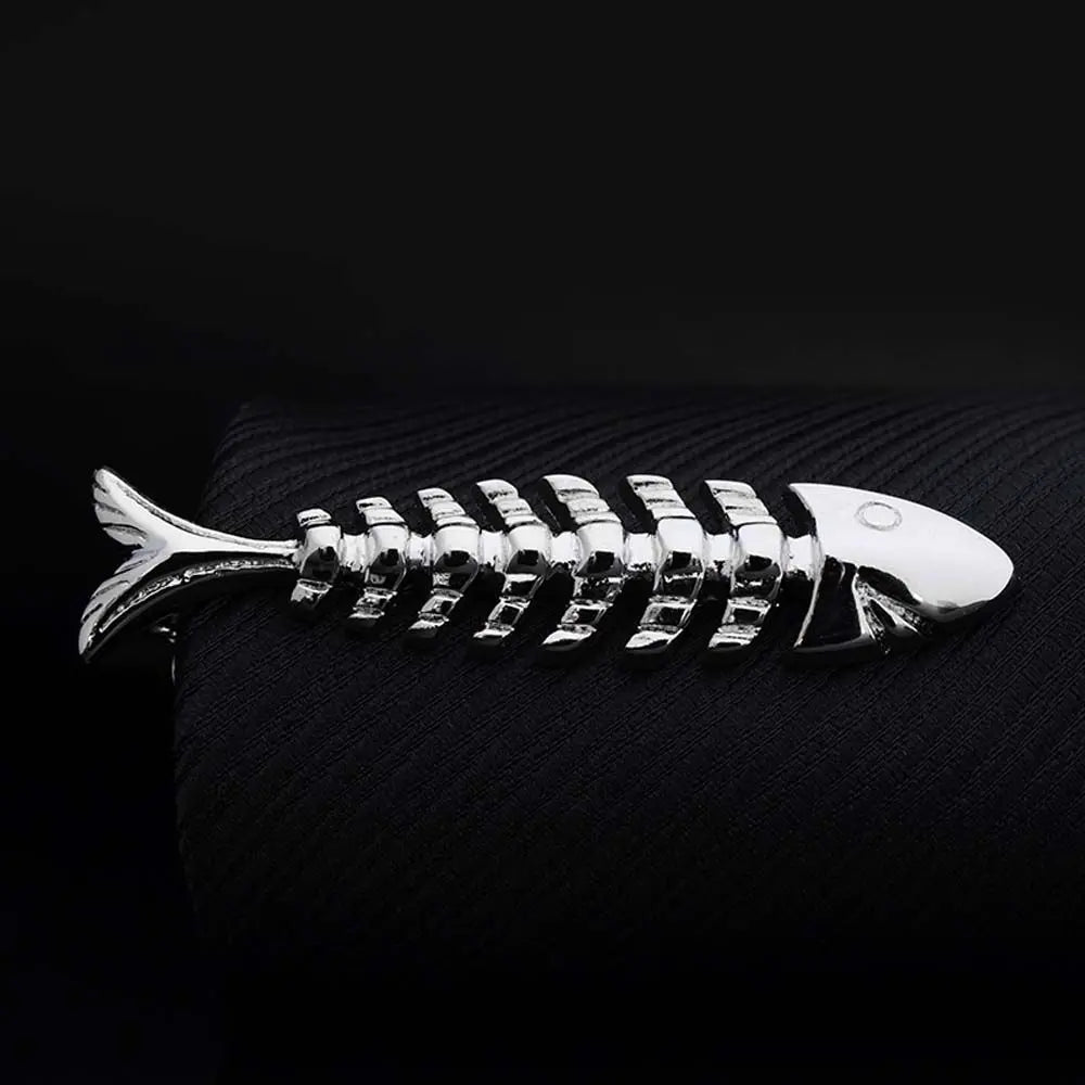 Metallic fish skeleton ornament on a dark textured surface