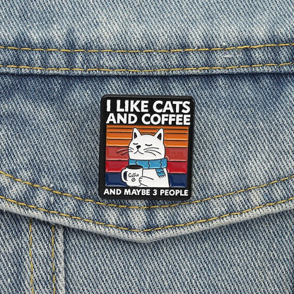 Enamel pin with cat and coffee design on denim fabric