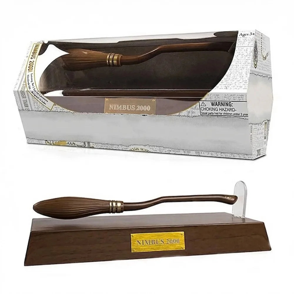 Wooden broom with gold accents on a stand and in packaging, labeled 'Nimbus 2000'.
