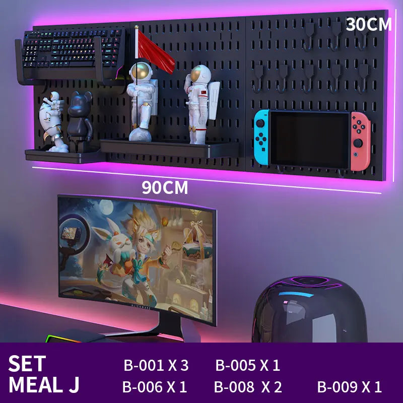 Gaming setup with monitor, keyboard, and decorative items on a wall-mounted shelf.