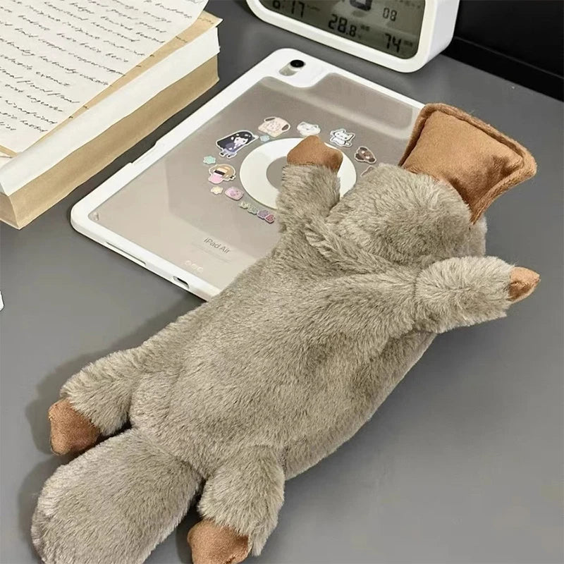 Plush toy resembling a bear on a tablet with a book and alarm clock in the background