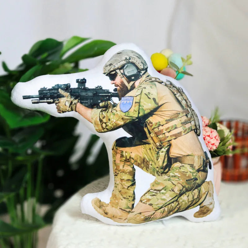 Decorative pillow with a soldier in camouflage holding a rifle on a white background