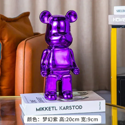 Purple bear-shaped figurine on a stack of books with a blurred background
