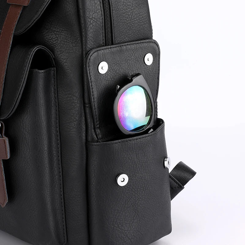 Black backpack with a colorful object in a pocket on a white background