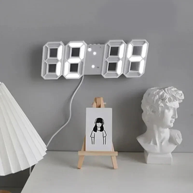 Digital clock on a gray wall with a white lamp and sculpture in the foreground