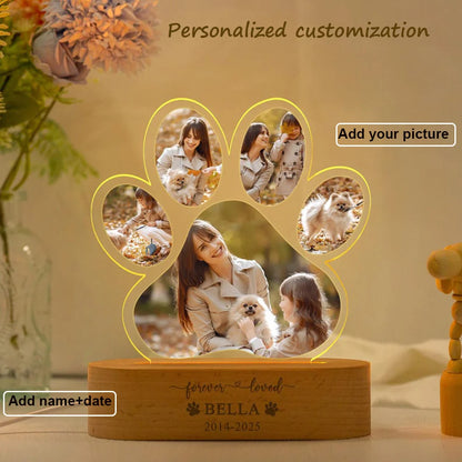 Personalized paw-shaped photo frame with family photos and engraving on a wooden base.