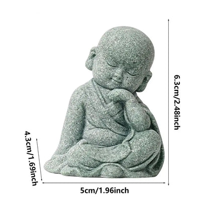 Small stone statue of a meditating figure with dimensions indicated on a white background