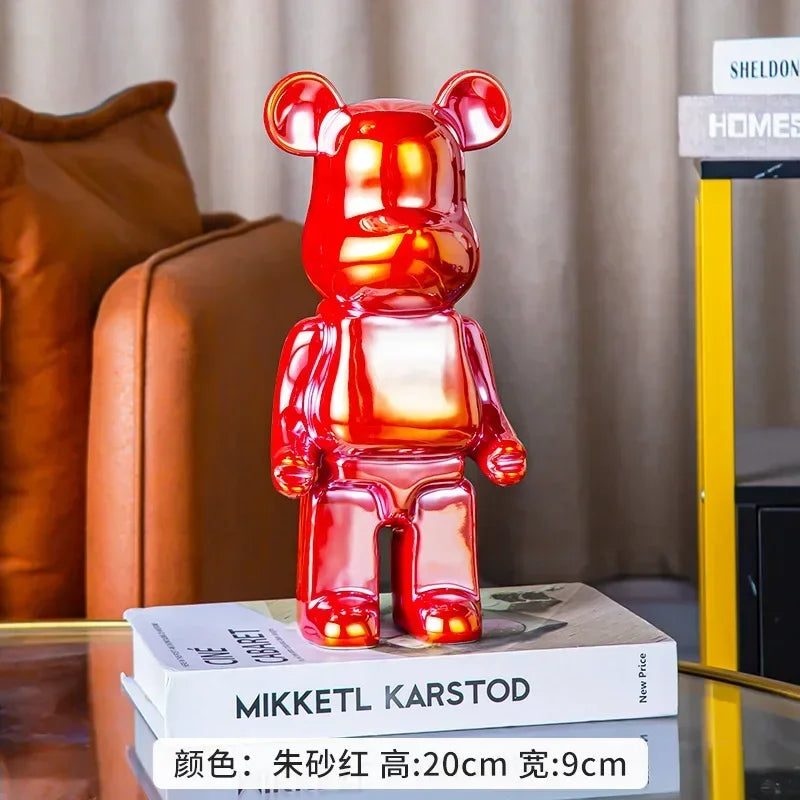 Red bear-shaped figurine on a stack of books with a blurred background