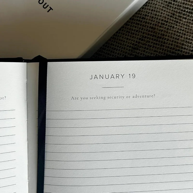 Open notebook with lined pages and text on a textured surface