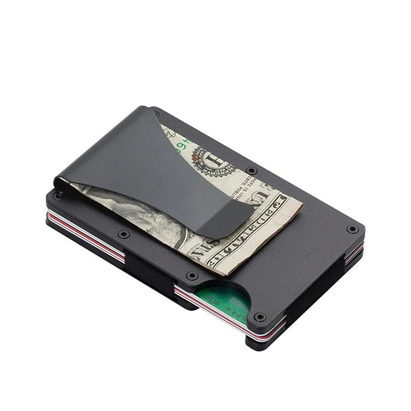 Black metal money clip holding a dollar bill on a white background