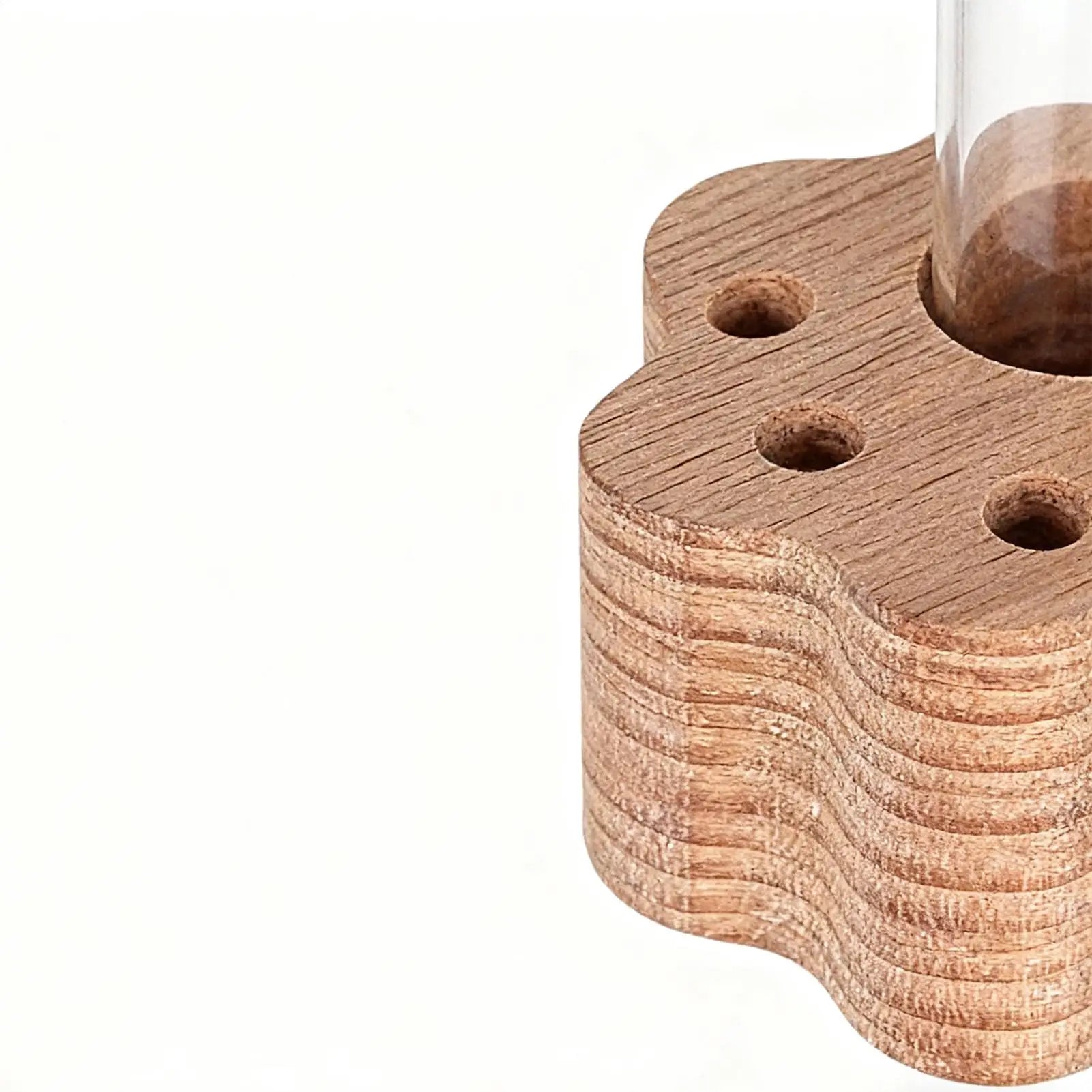 Wooden candle holder with wavy design on a white background