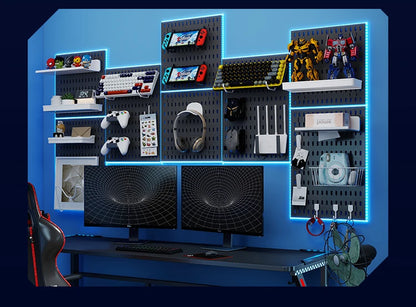 Gaming setup with monitors, gaming chairs, and accessories on a blue wall.