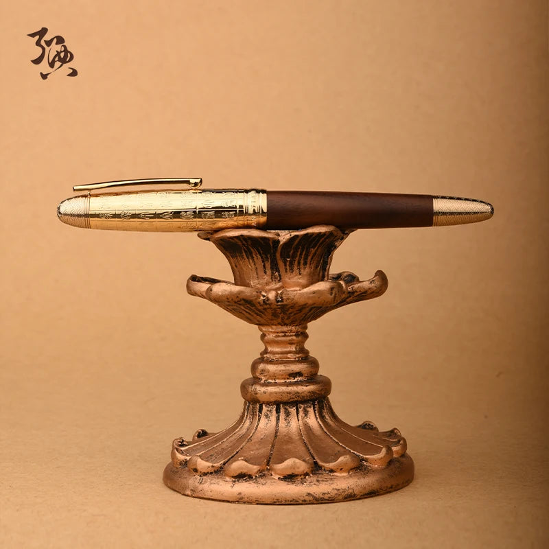 Decorative pen holder with a gold and brown pen on a beige background