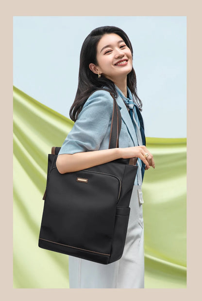 Woman holding a black backpack against a light green background